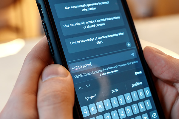 Phone with open ChatGPT app with prompt to write a poem