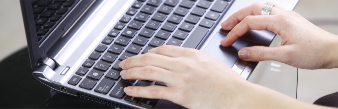Fingers on laptop keyboard