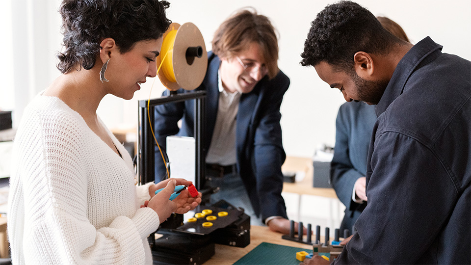 Group of people working with a 3D printer