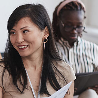 People interacting and reading in a seminar setting.