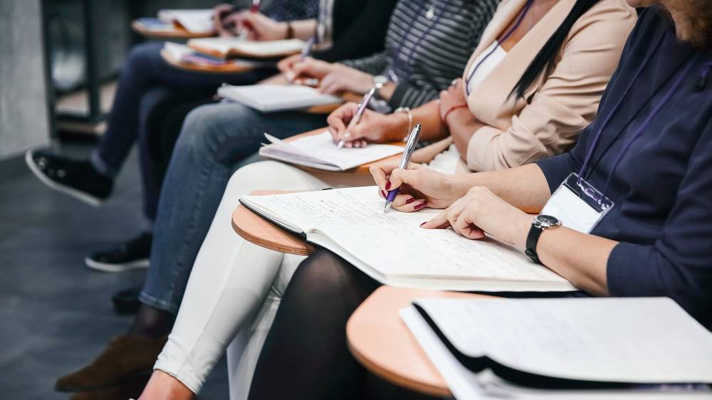 Participants taking notes at a workshop