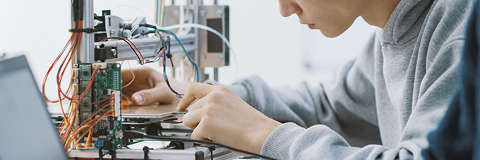 Student working on a technology as part of a research project