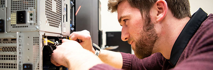 Student fixing a computer.