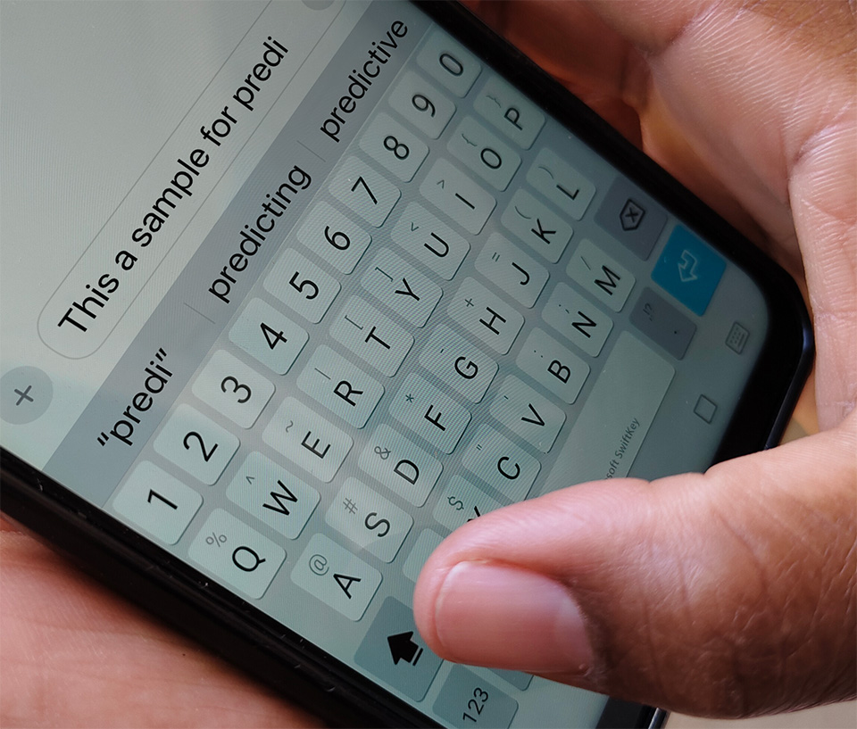 typing text into a phone as the application predicts content