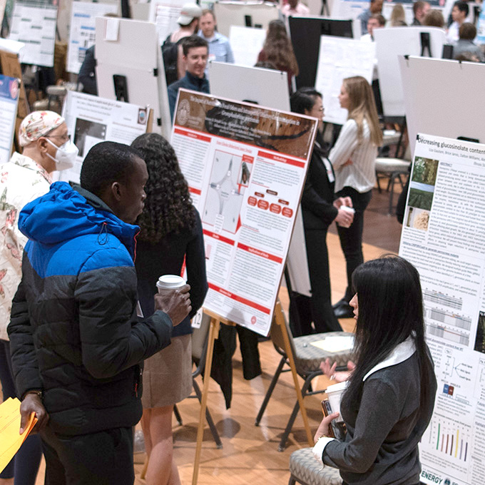 People at the Research Symposium with poster printed at CIPD